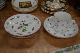 Porcelain coffee cup and saucer and a pair of decorative saucer dishes.