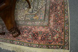 A Persian design carpet, cream and pink ground decorated with animals, birds etc 280cm x 185cm.