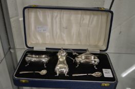 A boxed three piece silver cruet set.
