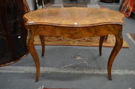 A 19th century figured walnut and marquetry inlaid centre table with shaped top, single frieze
