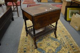 A Victorian inlaid rosewood drop flap two tier occasional table.