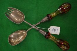 A pair of plated salad servers with cut glass handles.