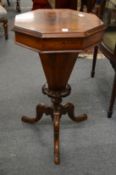 A Victorian walnut octagonal shaped sewing table.