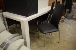 Modern laminated dining table and six chairs.