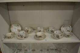 A collection of eight Herend porcelain cups and saucers painted with birds and butterflies.