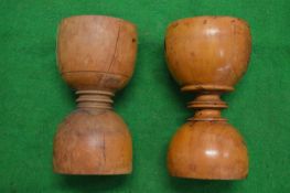 A pair of turned wood cups.