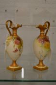 A near pair of Royal Worcester blush ivory miniature ewers with floral decoration.