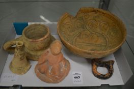 An early terracotta bowl and other similar items in excavated condition.
