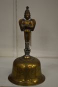 An Eastern brass hand bell.