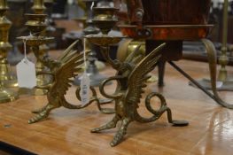 A pair of brass dragon candlesticks.