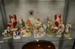 A good collection of Staffordshire figures to include dogs, birds, spill vases etc.