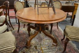 A 19th century pollard oak oval tilt top pedestal dining table.