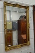 A decorative gilt framed mirror.