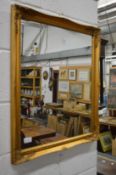 A gilt framed wall mirror.