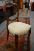 A set of six Victorian walnut dining chairs.