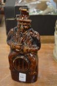 A figural treacle glazed flask.
