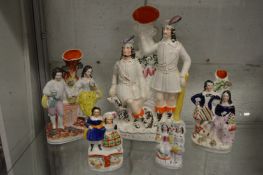 A group of Staffordshire figures and spill vases.