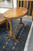 An Edwardian inlaid mahogany oval stretcher table.