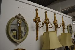A pair of painted oval decorative wall mirrors.