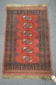 A small Bokhara style rug 100cm x 62cm.