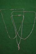 Three silver neck chains.