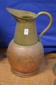 A large copper and brass jug.