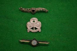 Three silver brooches.