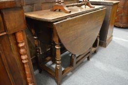 An oak dropleaf gateleg dining table.