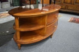 A modern yew wood oval shaped two drawer double sided coffee table.