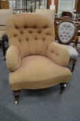 A Victorian button upholstered armchair.