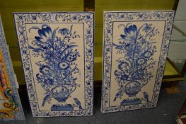 A pair of blue and white tile panels depicting flowers in an urn.