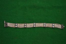A silver and moonstone bracelet.