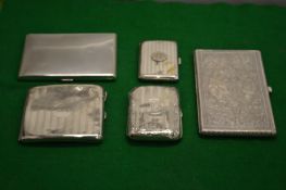 Four silver cigarette cases and an Eastern white metal cigarette case with engraved decoration.