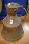An Eastern copper and brass ewer.