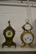 Two decorative mantel clocks.