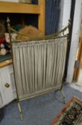 A brass firescreen.
