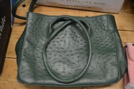 A ladies green leather handbag.