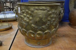 A brass jardiniere with mask handles.