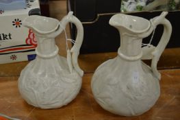 Two white moulded pottery jugs.