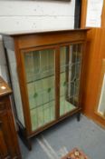 An Edwardian inlaid mahogany two door display cabinet with leaded light doors.