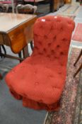 A Victorian crimson upholstered button back nursing chair.