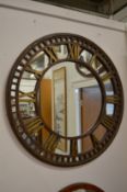 A large metal clock face mirror.