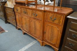 A reproduction mahogany breakfront sideboard.
