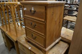 A small pine three drawer chest.