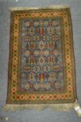A small Persian style rug 87cm x 58cm.
