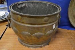 A large brass jardiniere with lion mask ring handle.