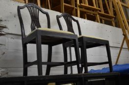 A pair of mahogany dining chairs.