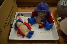 A wooden tray containing Paddington bears.
