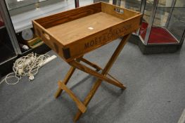 A pine tray on folding stand.