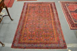 A Persian style rug, pink ground with all-over stylised decoration 200cm x 130cm.
